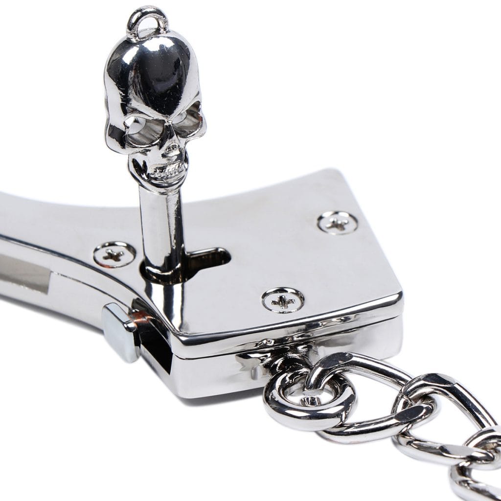 ready to open a silver stainless steel handcuffs use key
