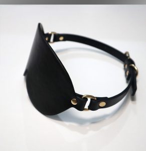 a black bdsm masks on table
