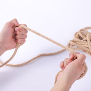 a hemp bondage rope in hand
